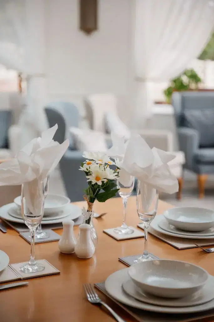 resident of Bolton's residential care home community, Starmount Villa, enjoys the high quality dining experience with first class dining setting