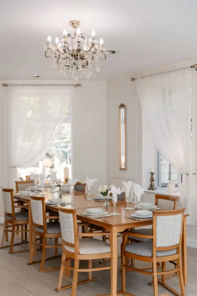 dining room table and chairs set with elegant cutlery in Starmount Villa Residential Care Service in Bolton