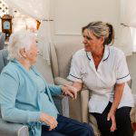 nursing staff sit with care home resident's in Bolton's leading residential care home Starmount Villa