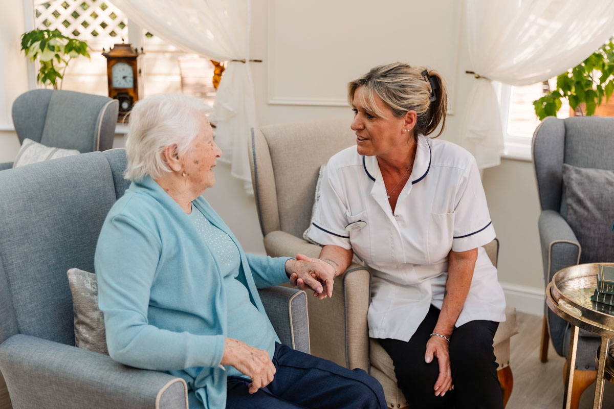 nursing staff sit with care home resident's in Bolton's leading residential care home Starmount Villa